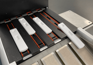 Multiple lateral flow assay production lines inside a CMO facility