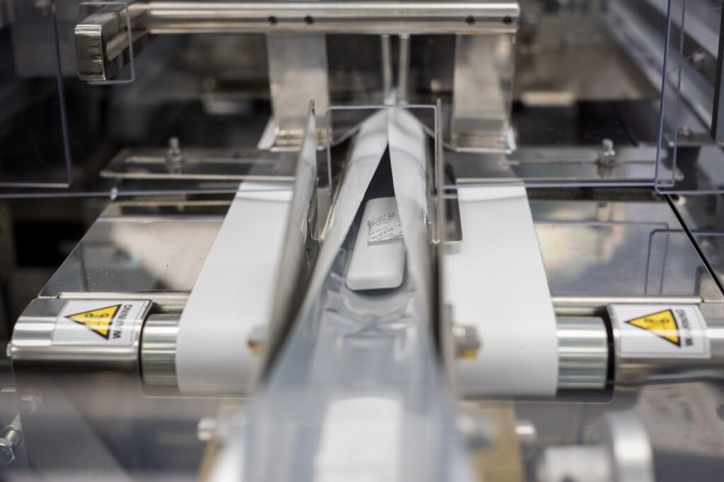 lateral flow tests going through manufacturing machinery 